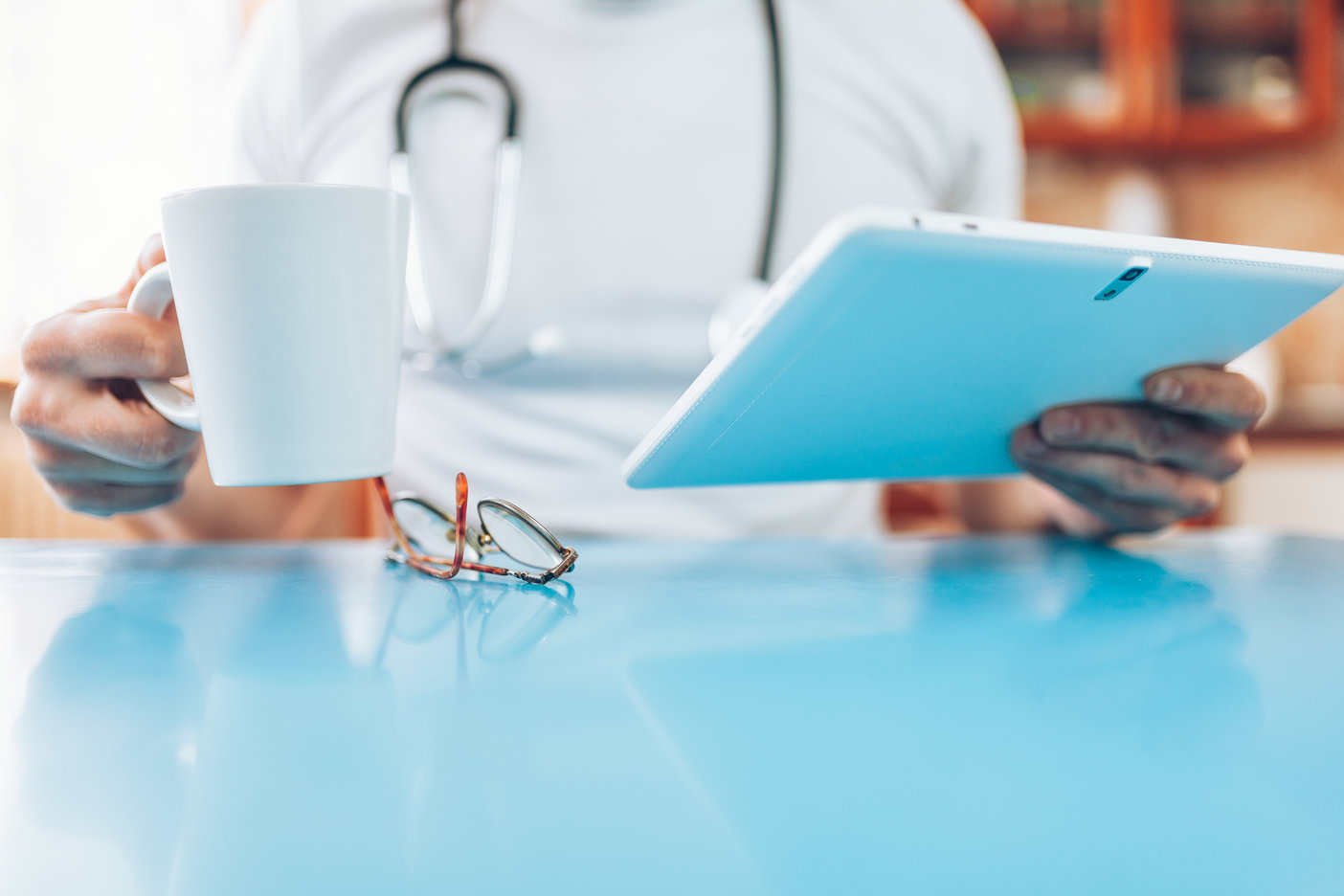 Doctor in his practice with a digital tablet