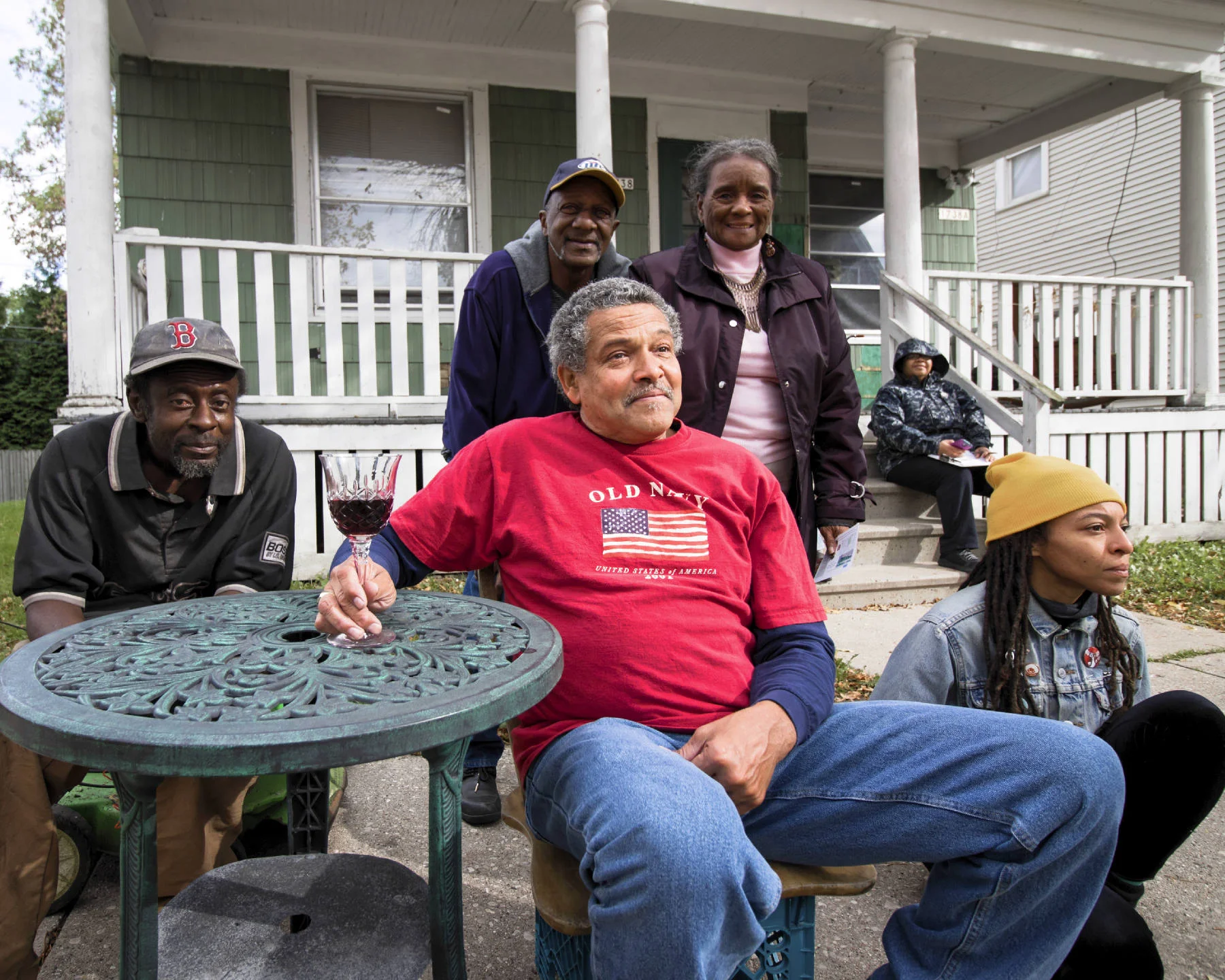 Al Paterson (center), viewing dancers performing a site-specific improvisation on and around his house with neighbors.