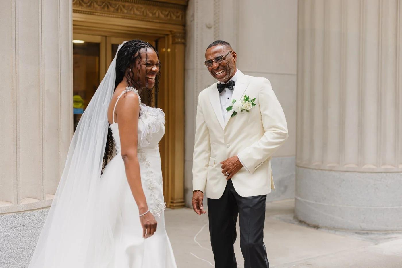 Bride and groom laughing after their first look