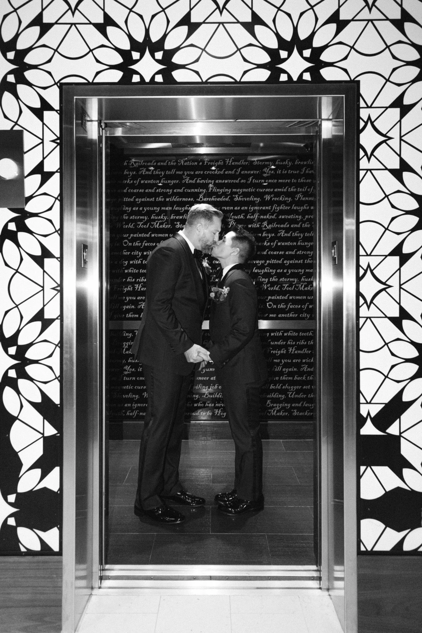 Grooms kissing in an elevator