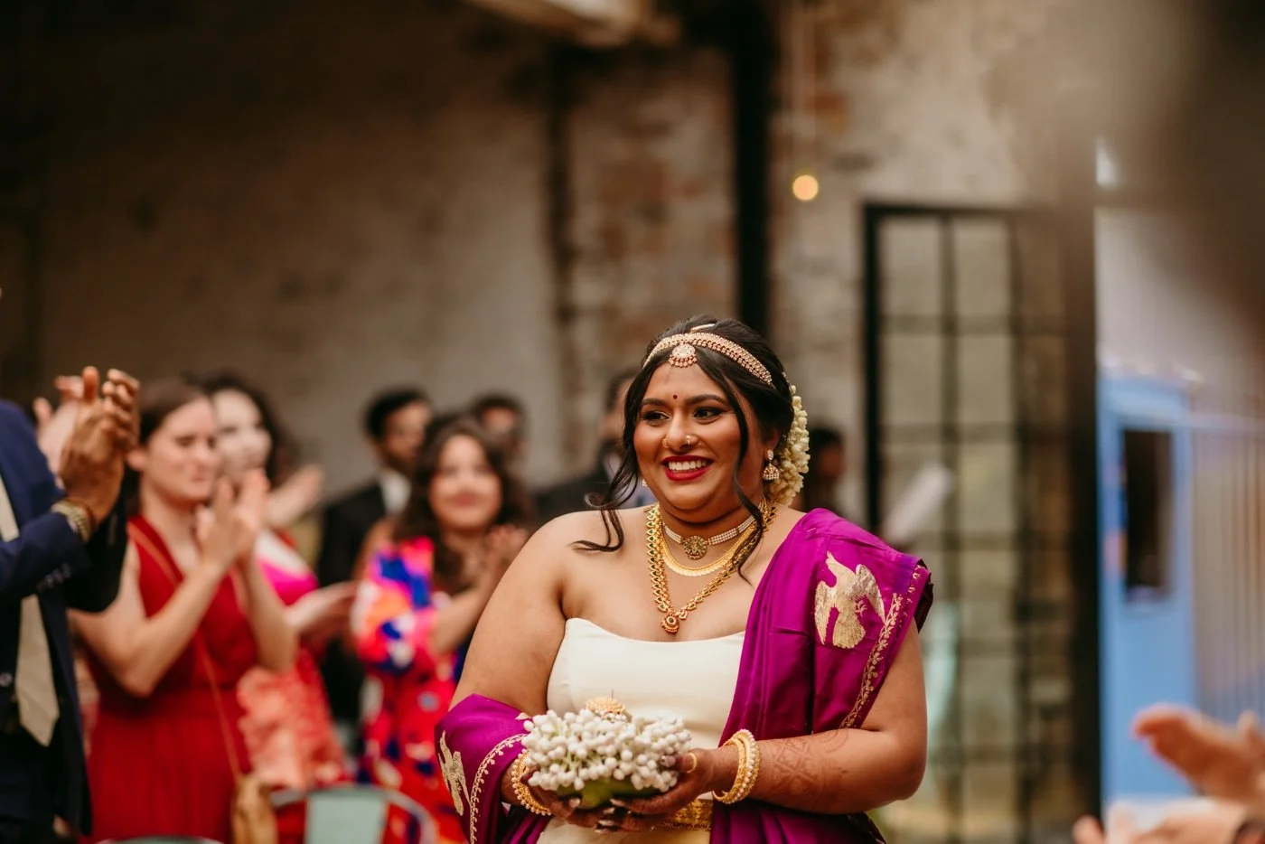 Bride walking down the aisle in a traditional Indian wedding ceremony