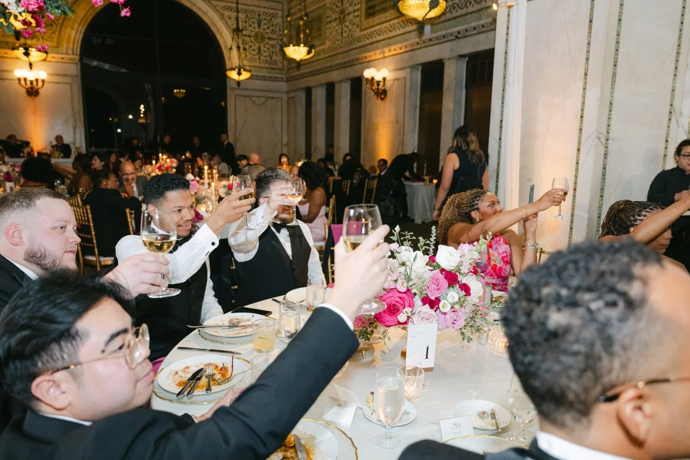 Wedding guests raising their glasses for a toast