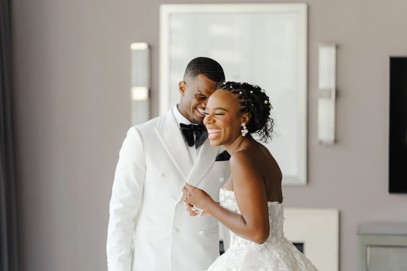 Bride and groom laughing after their first look