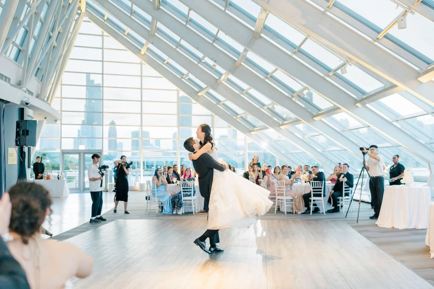 Groom lifting bride for their first dance