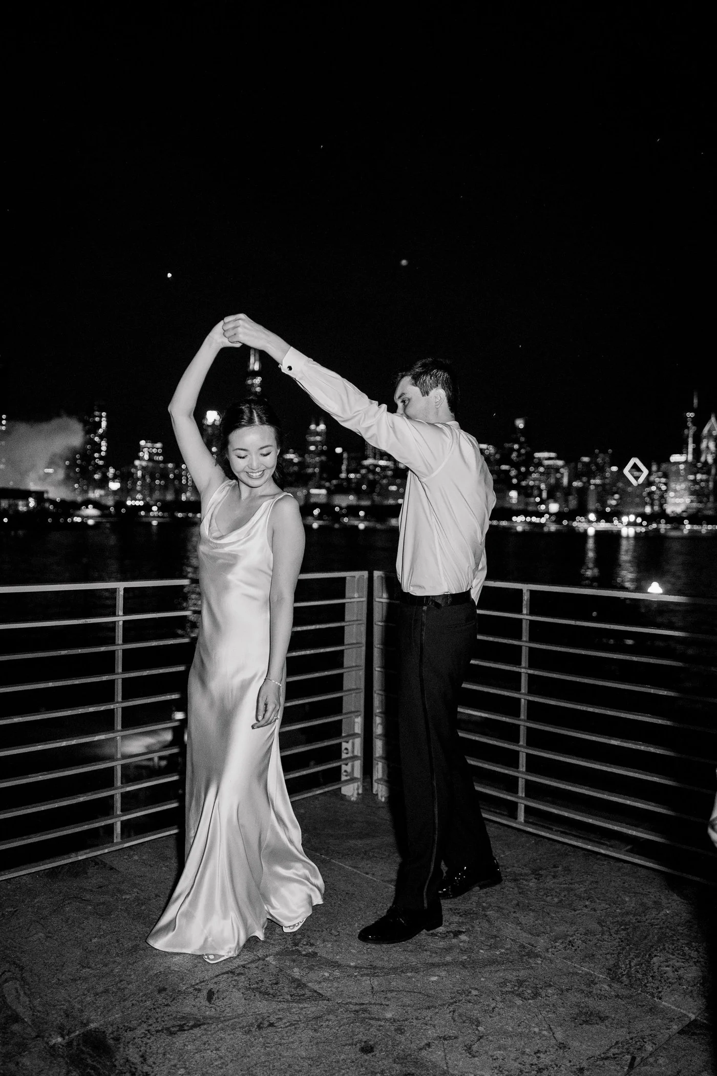 Bride and groom dancing on the balcony at the Adler Planetarium