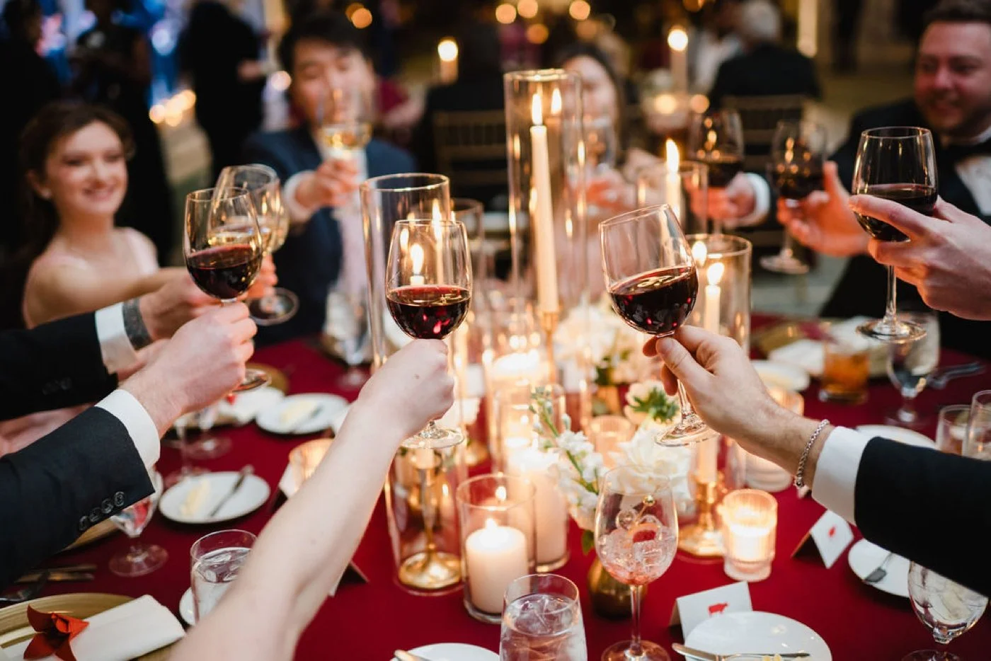 Guests toasting with glasses of red wine at a Chicago winter wedding