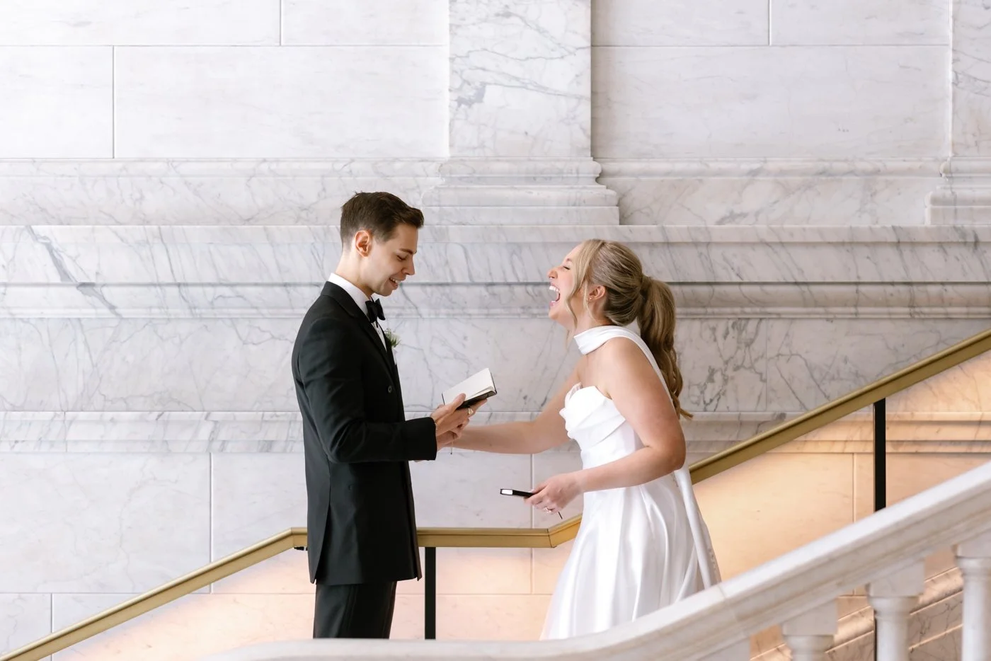 Bride and groom reading private wedding vows