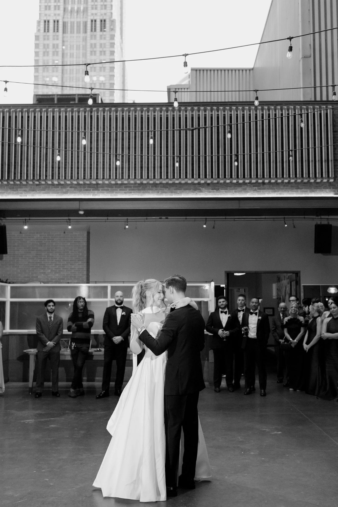 Bride and groom dancing on the rooftop at Boleo