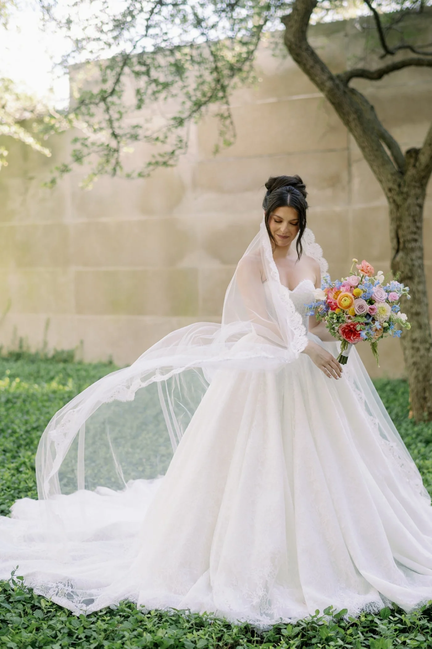 Bride wearing a Viero Bridal gown and lace mantilla veil