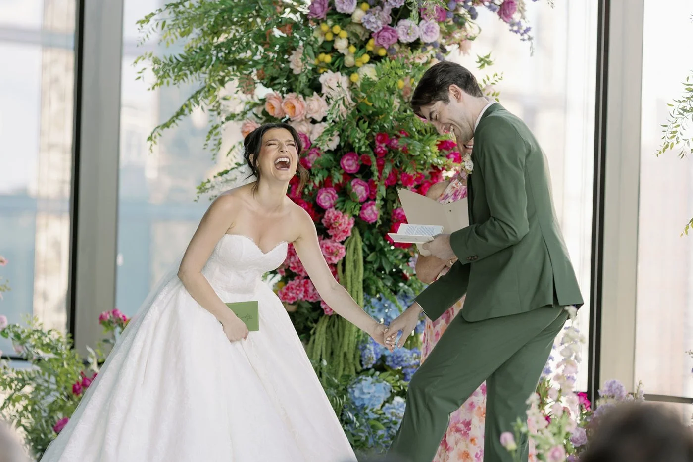 Bride and groom laughing while exchanging wedding vows