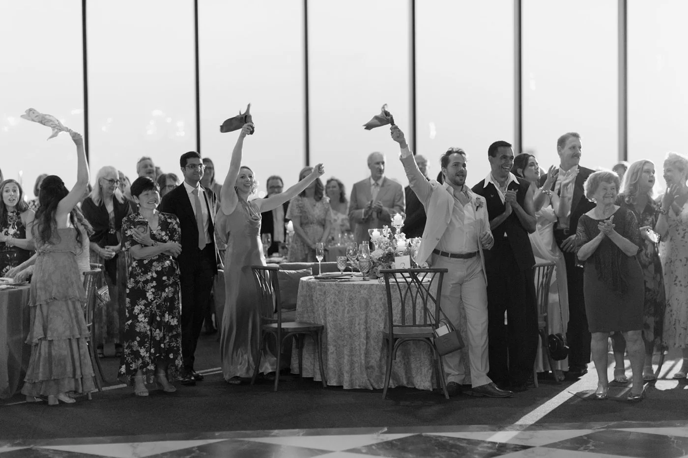 Wedding guests cheering for bride and groom, reception entrance