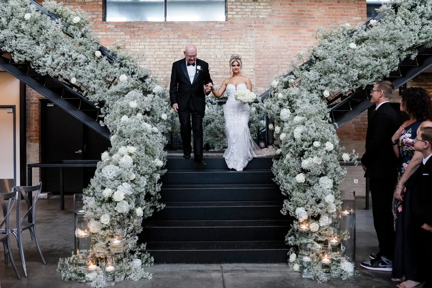 Staircase with white roses and baby's breath for bride's grand entrance