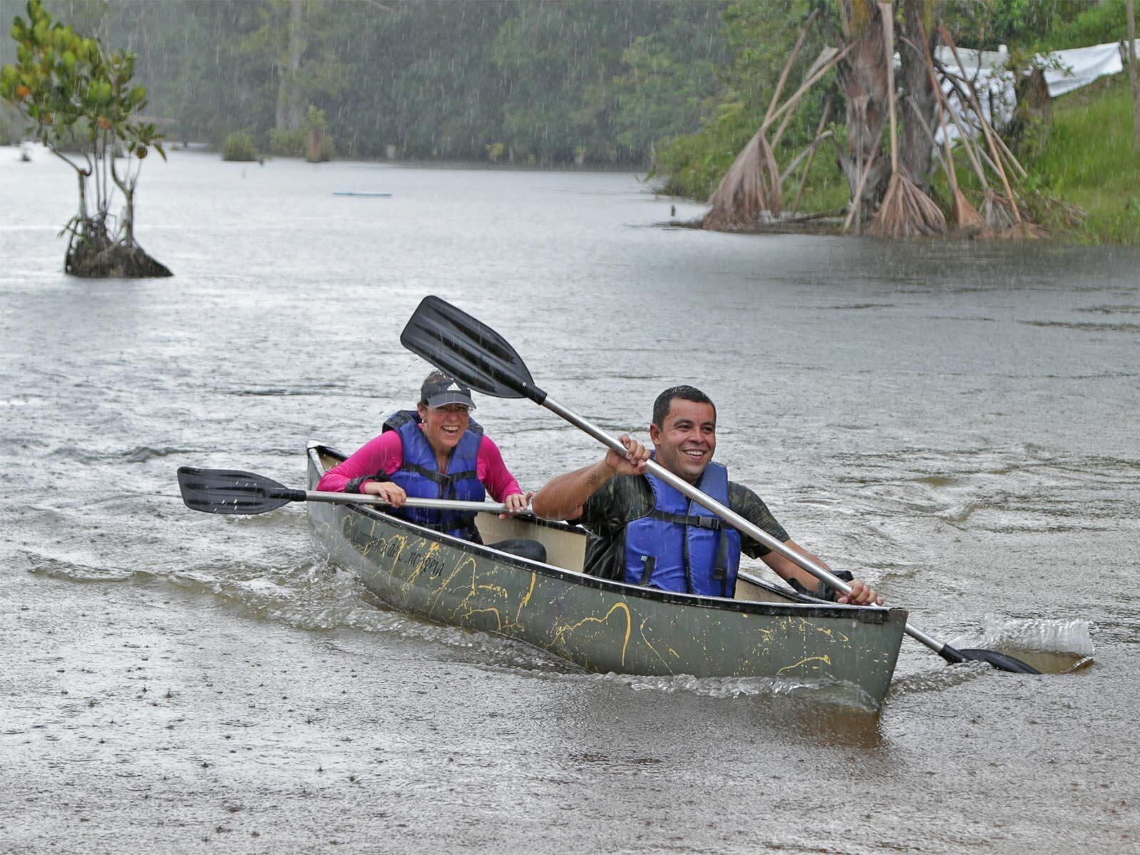 Couple canoeing in the rain.jpg