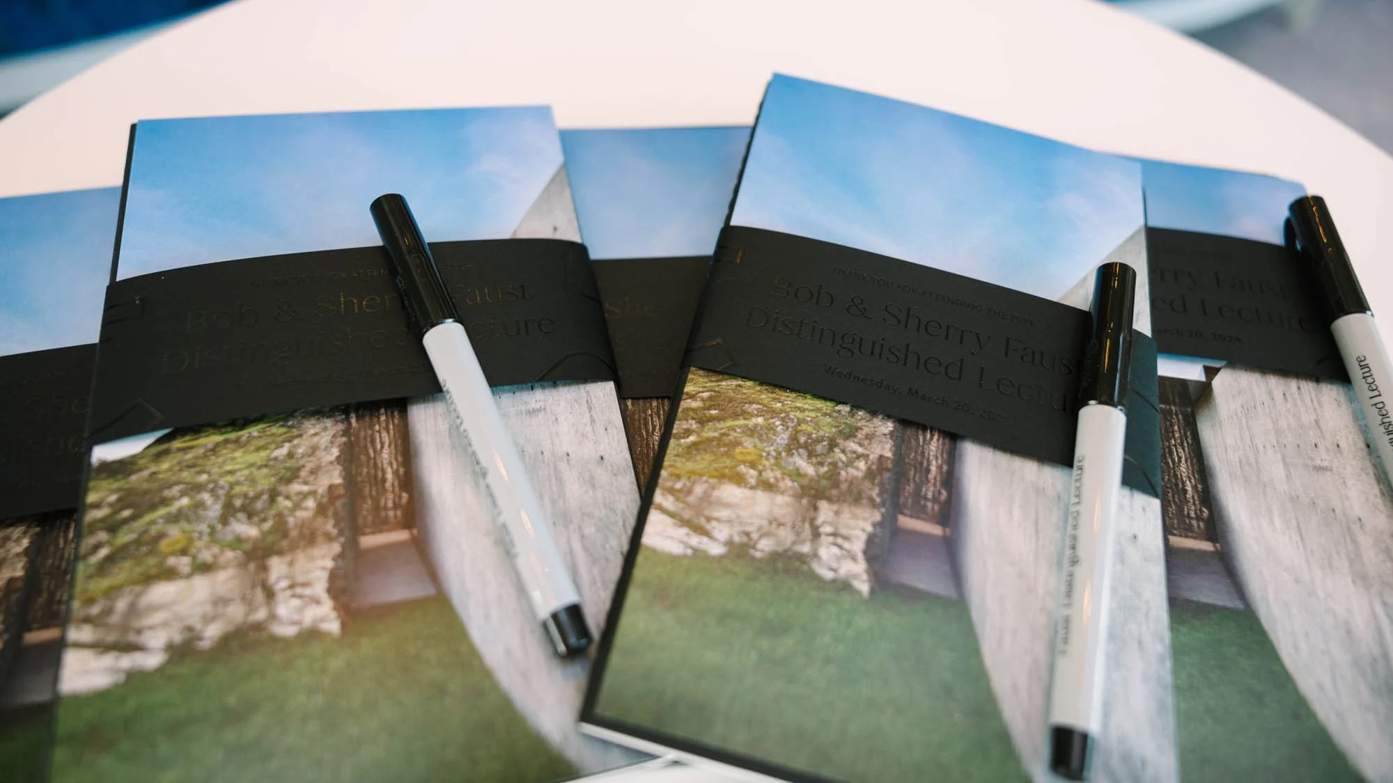  2024 program and bellyband  (tone-on-tone glossy ink on matte stock)  