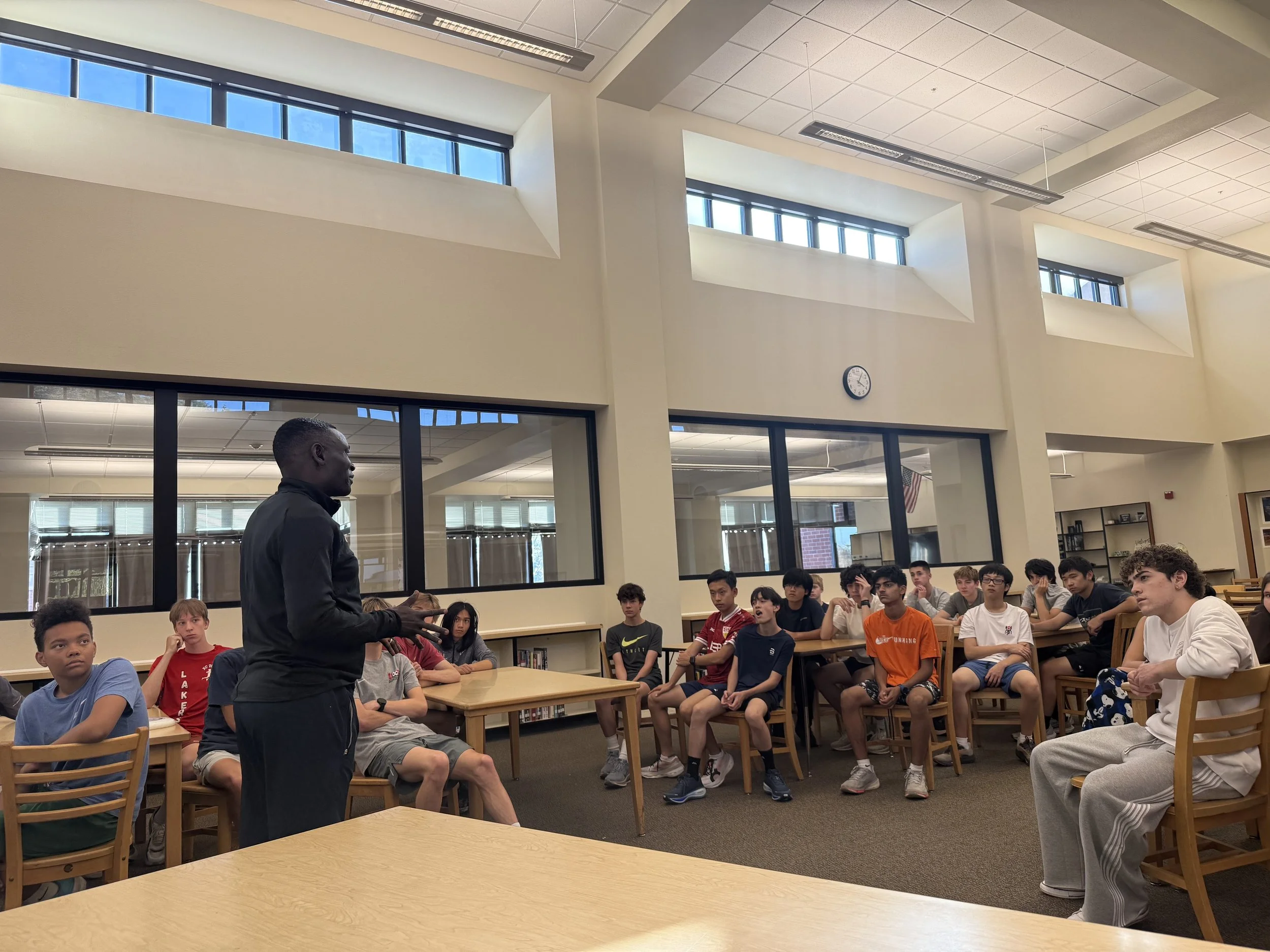 Julius Speaking to HS XC Team.jpg