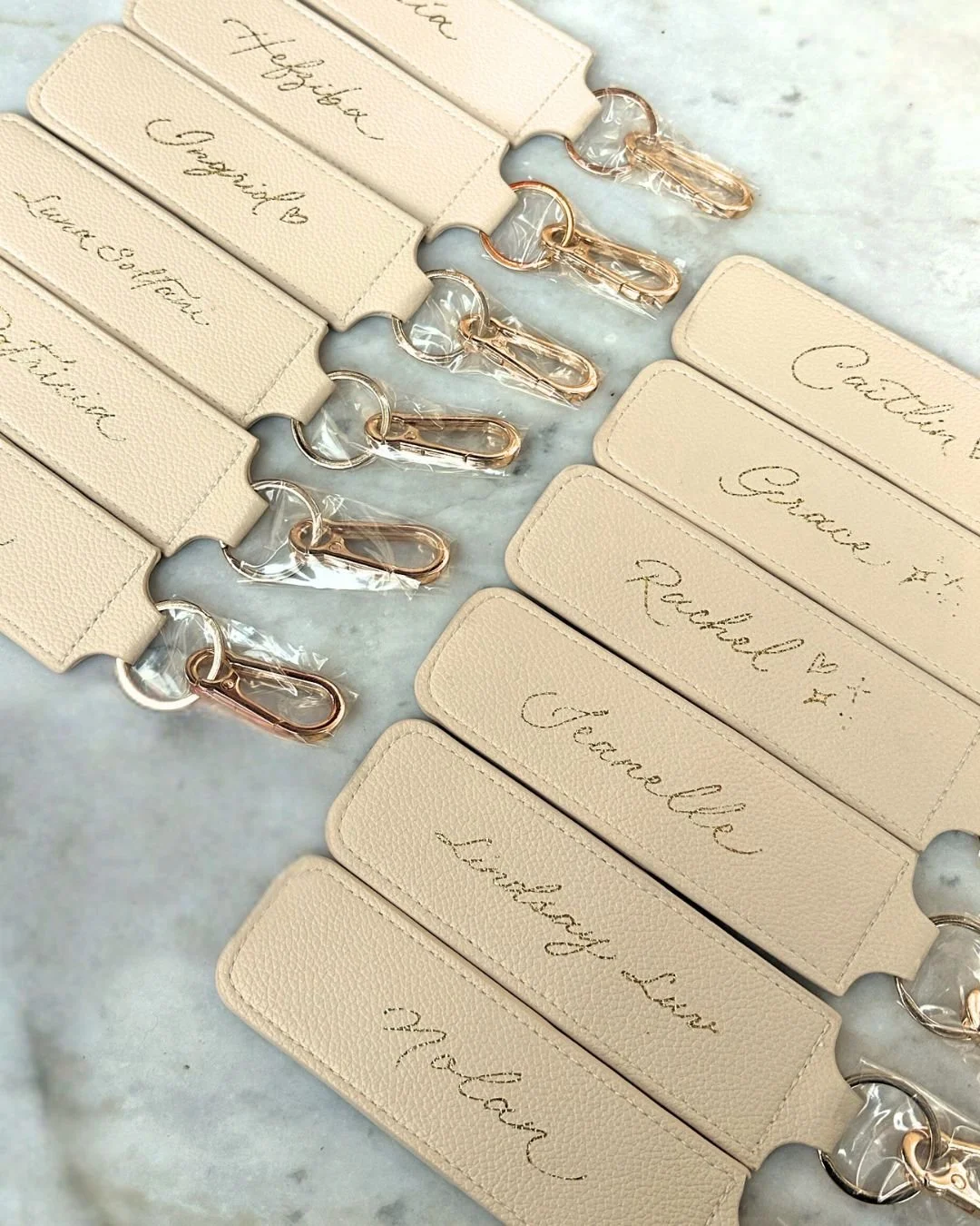 Gold foiling on leather keychains that hold lip glosses for Westmore Beauty product launch event on Melrose, California