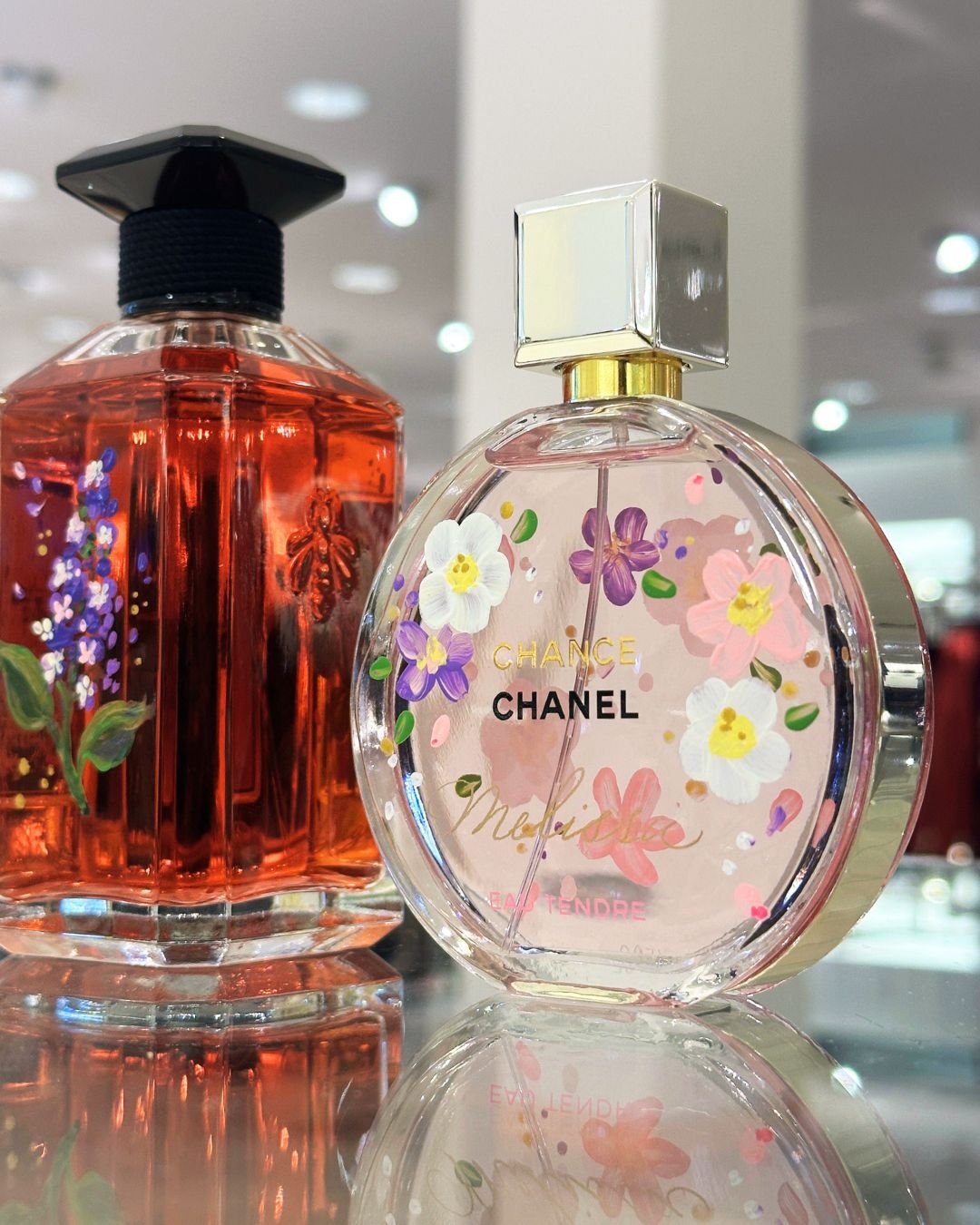 Chanel and Guerlain perfume bottle painting with floral designs at Neiman Marcus