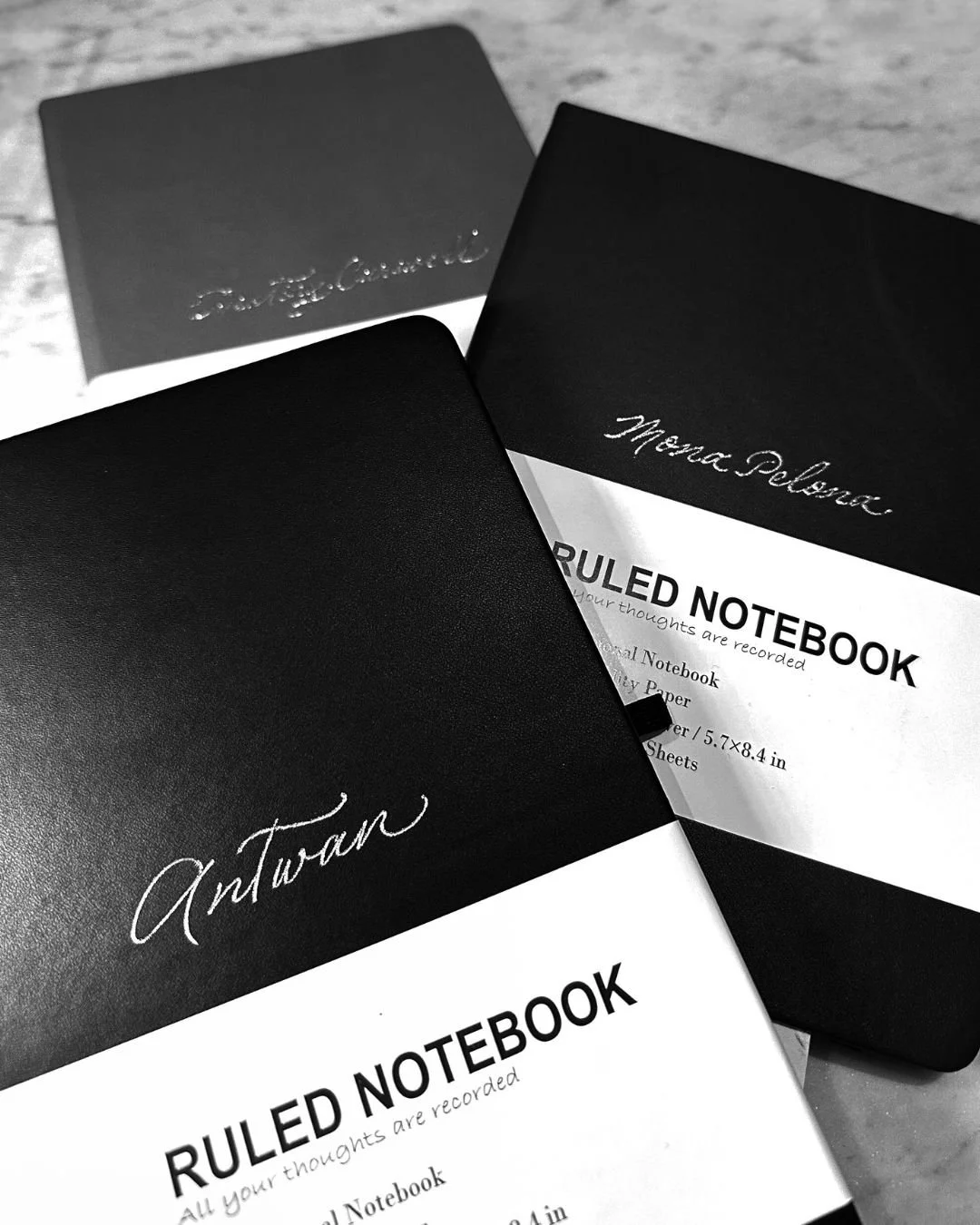 Calligraphy hot foiling on notebooks for corporate holiday party event favors