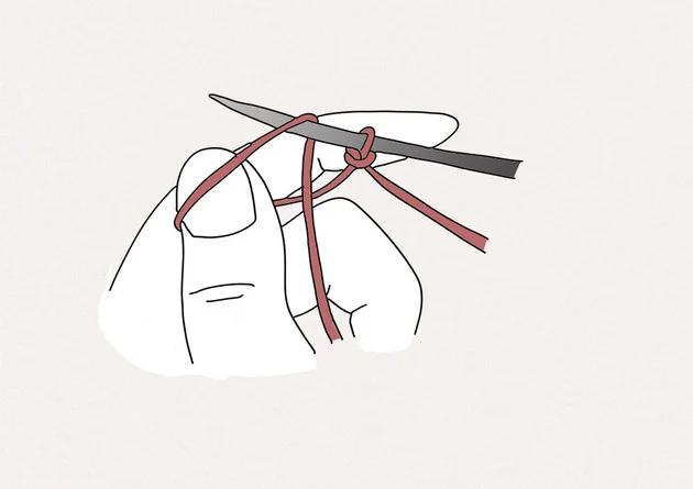 2. Passez l'aiguille dans la boucle formée par le pouce.