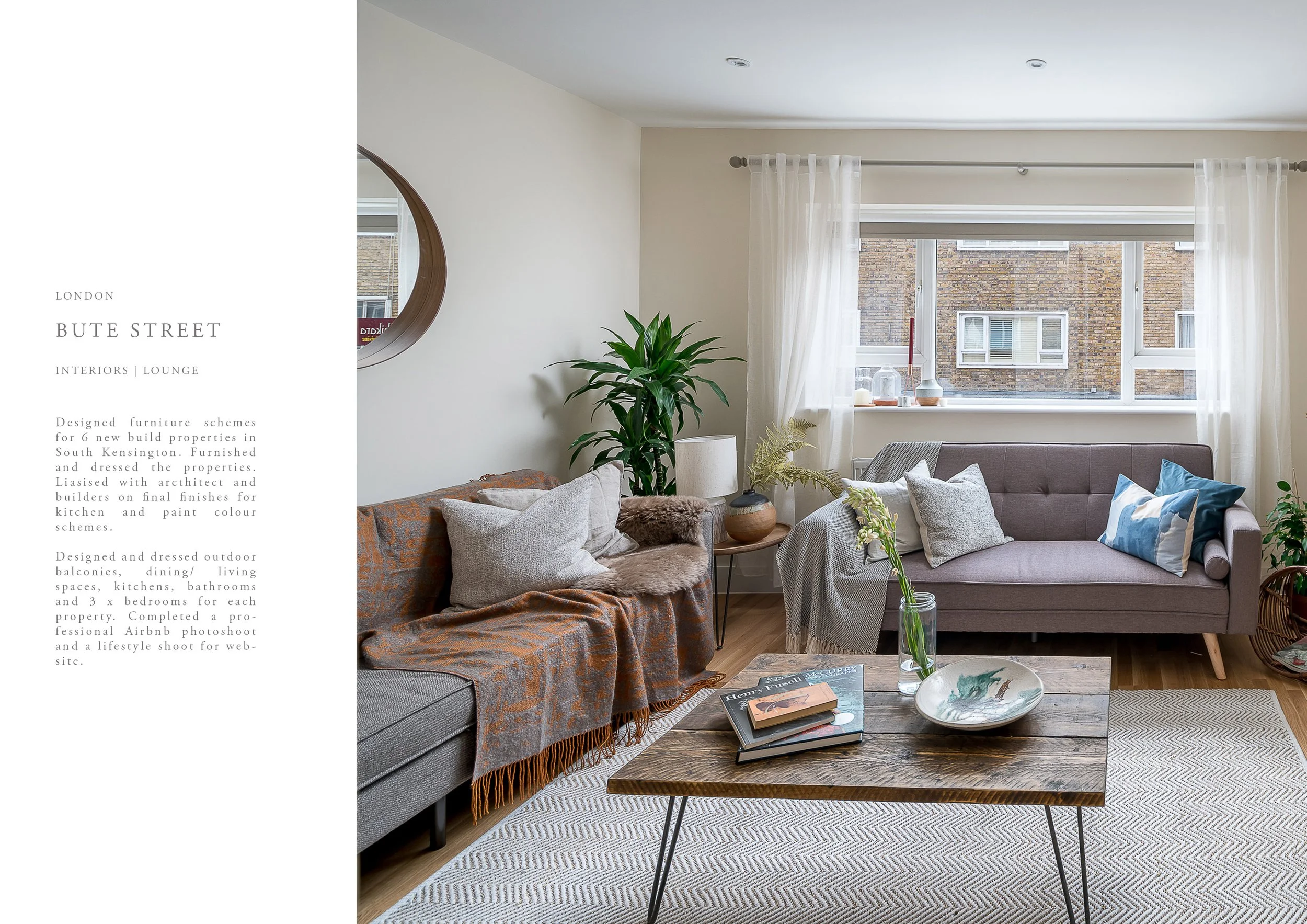 Living room with two sofas, a wooden coffee table, and a window with white curtains, decorated with plants, books, and cushions.