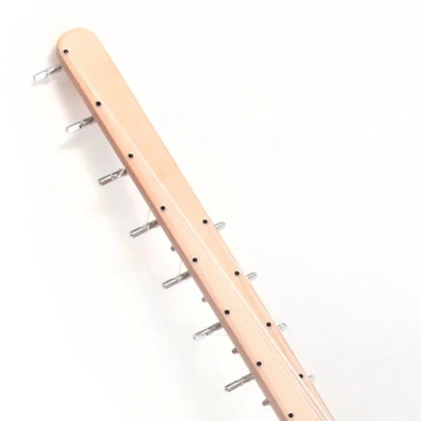 The neck of the Travel Kora &mdash; clean lines, polished hardware, and carefully aligned strings.
Each tuning peg and grommet is placed by hand for perfect tension and tone stability. Precision and simplicity, working together in harmony. 🎶

#trave