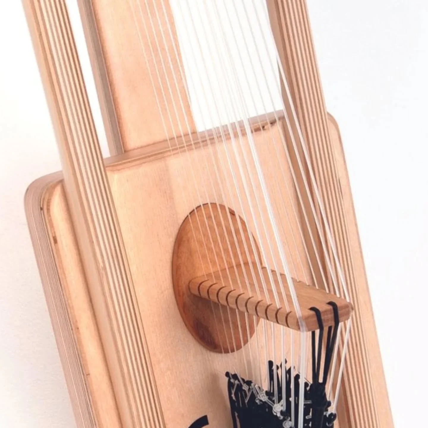 Of course &mdash; here&rsquo;s the English version with the reference included:

Clean lines, warm wood, and the heart of the Travel Kora &mdash; the bridge and strings coming together in one frame.
Inspired by the traditional African harp, yet built