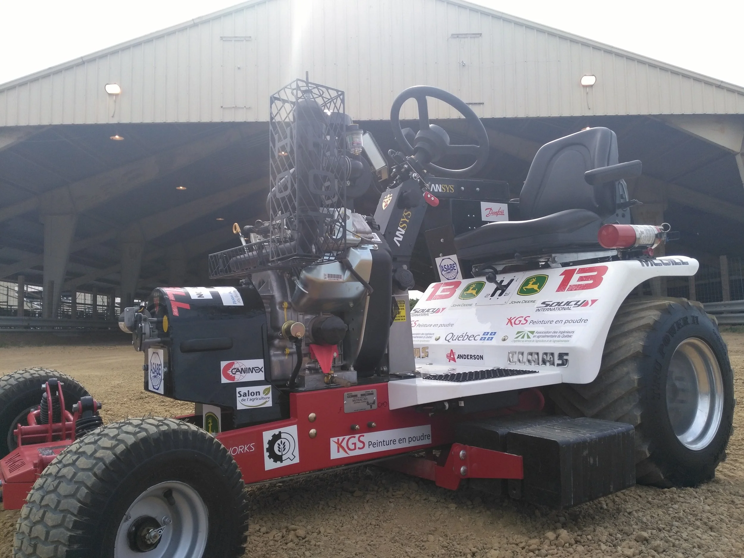 The logos of gold and platinum level sponsors are displayed on the tractor at competition.
