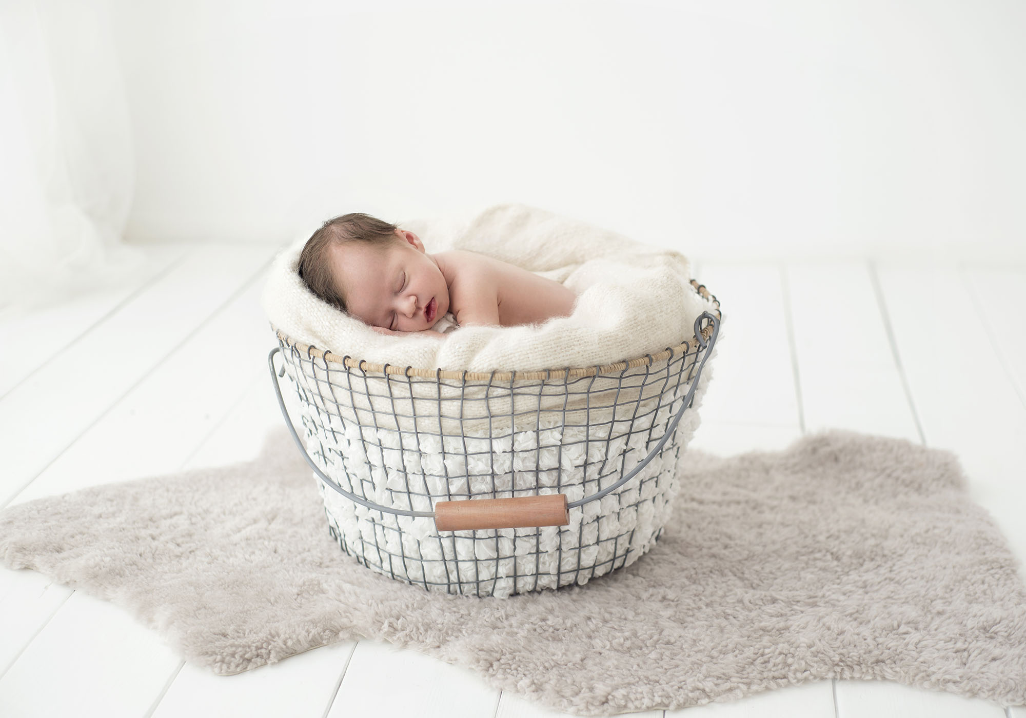 baby in basket minimalist