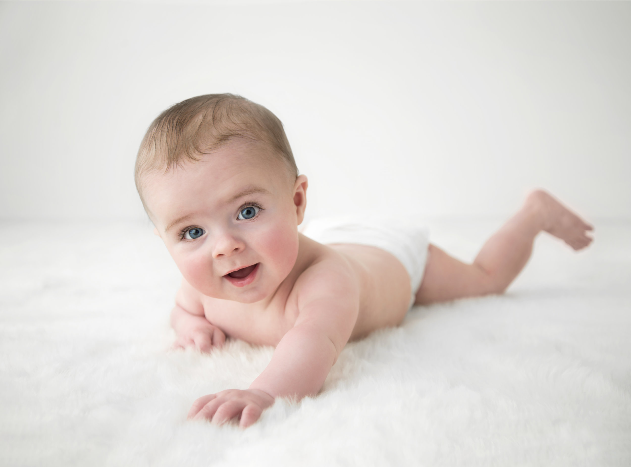baby boy crawling simple white rug