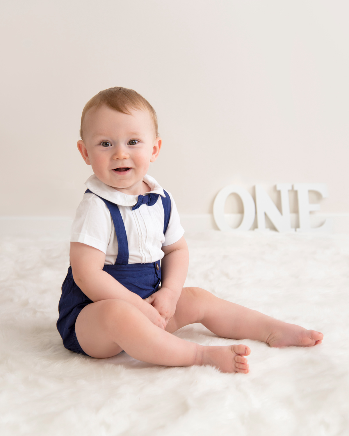 one year old baby with white letters