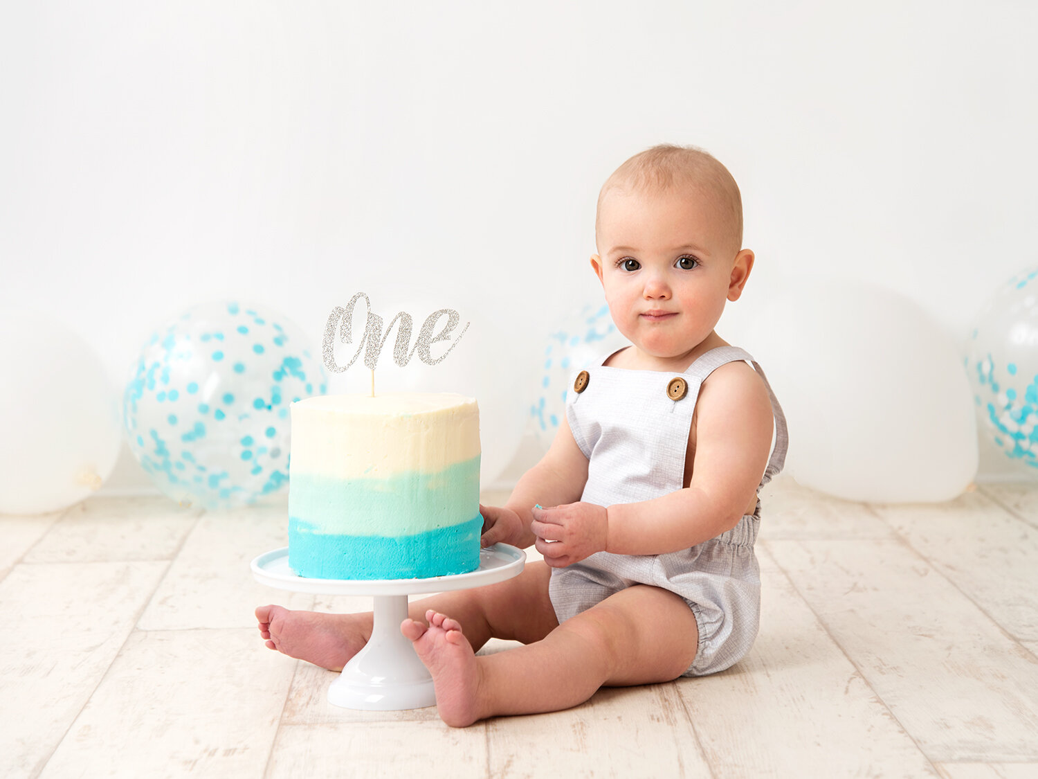 1 year old baby boy with blue cake smash
