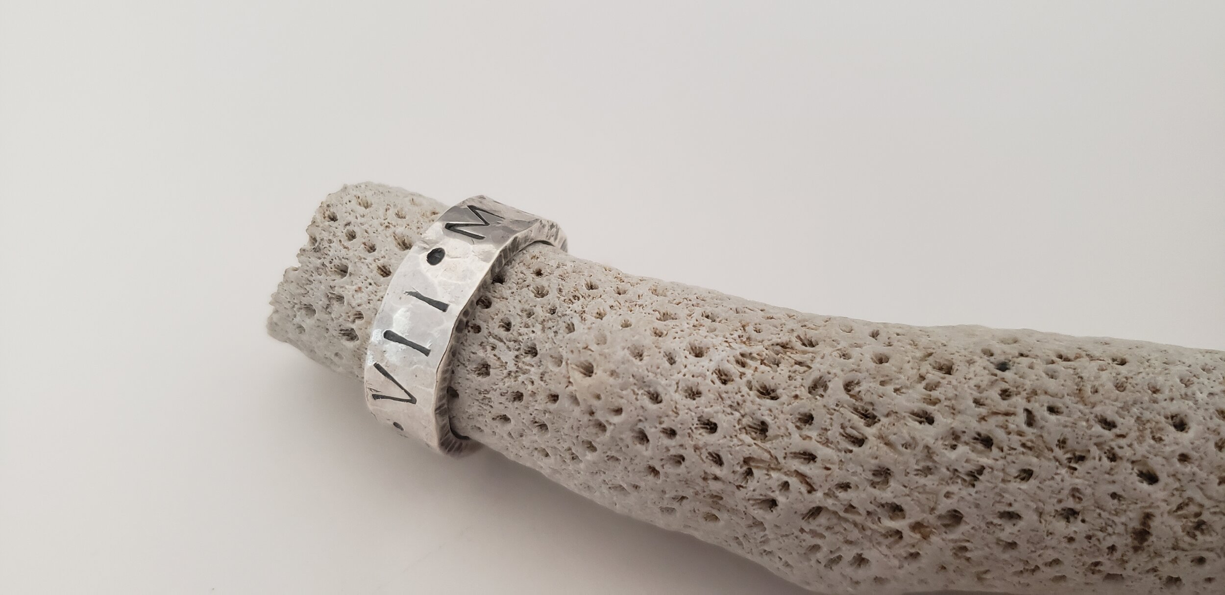 Jeri needed a wedding band. She wanted something simple, and comfortable enough to wear everyday. The Roman numerals of their ceremony made it super special.