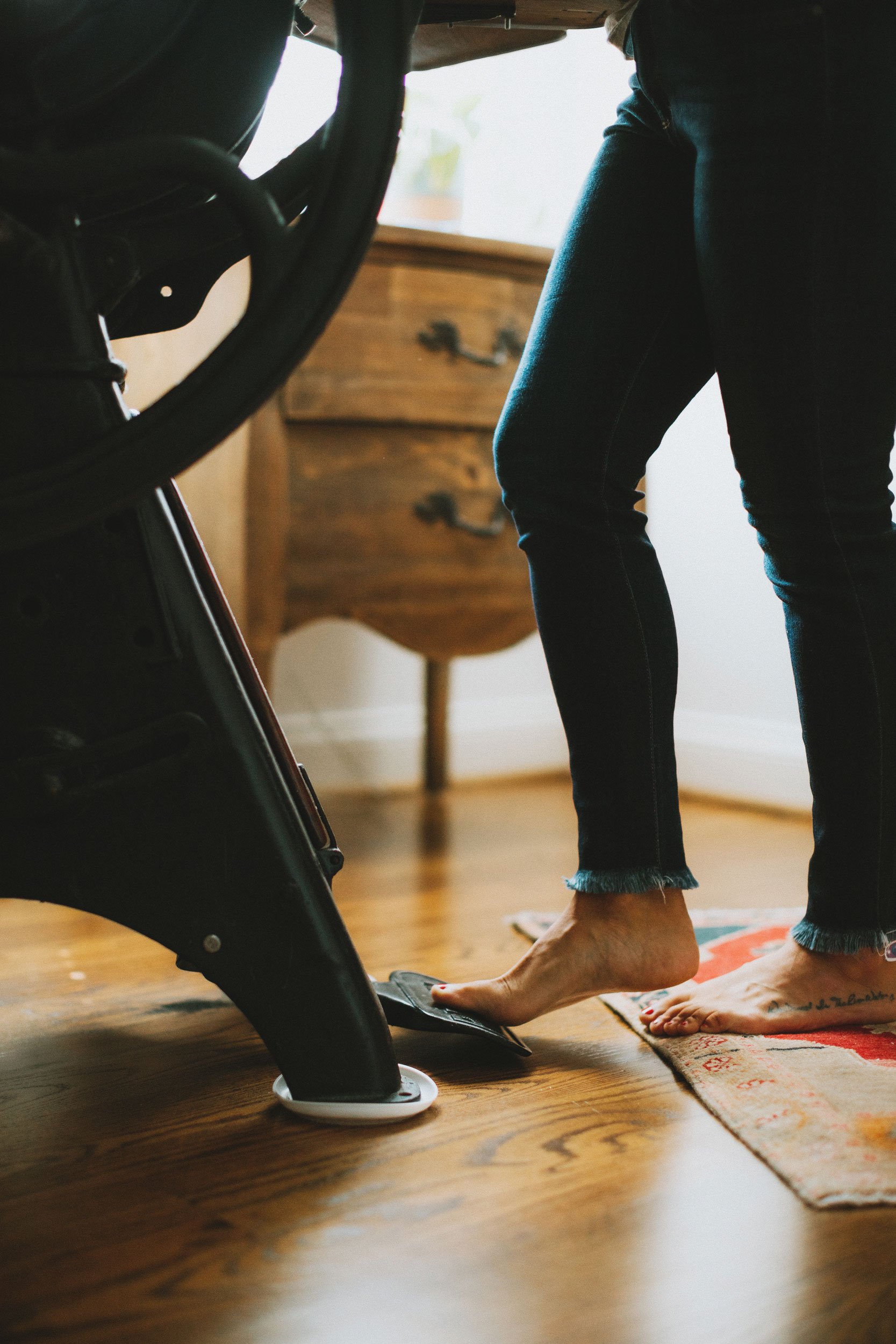 Erica's foot pressing the pedal on the press.