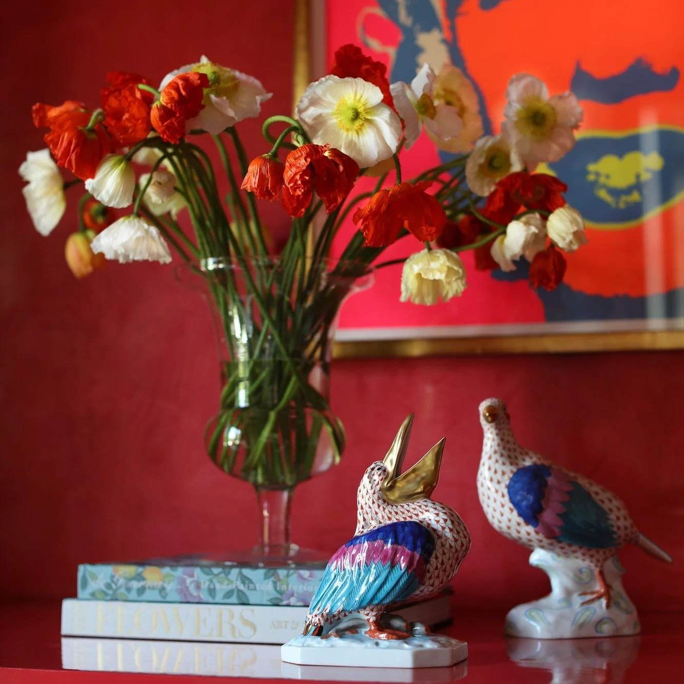 Interiors Photography: poppies and porcelain birds on a red lacquer shelf in front of a Warhol