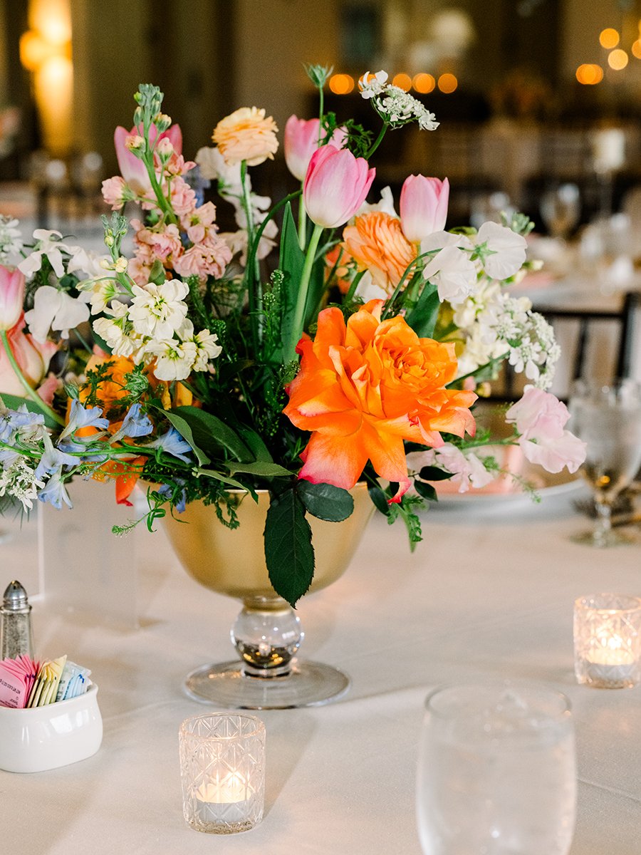 Colorful floral centerpiece designed by Belli Fiori for a wedding reception in St. Louis.