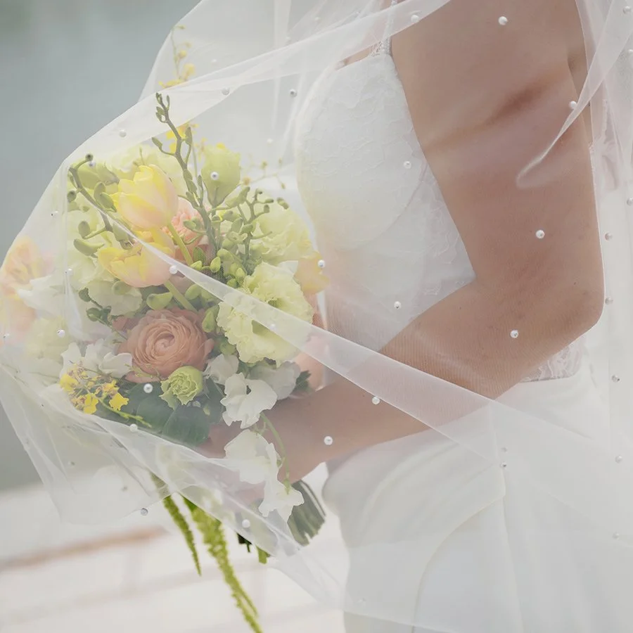 Bride holding wedding bouquet designed by Belli Fiori in St. Louis.