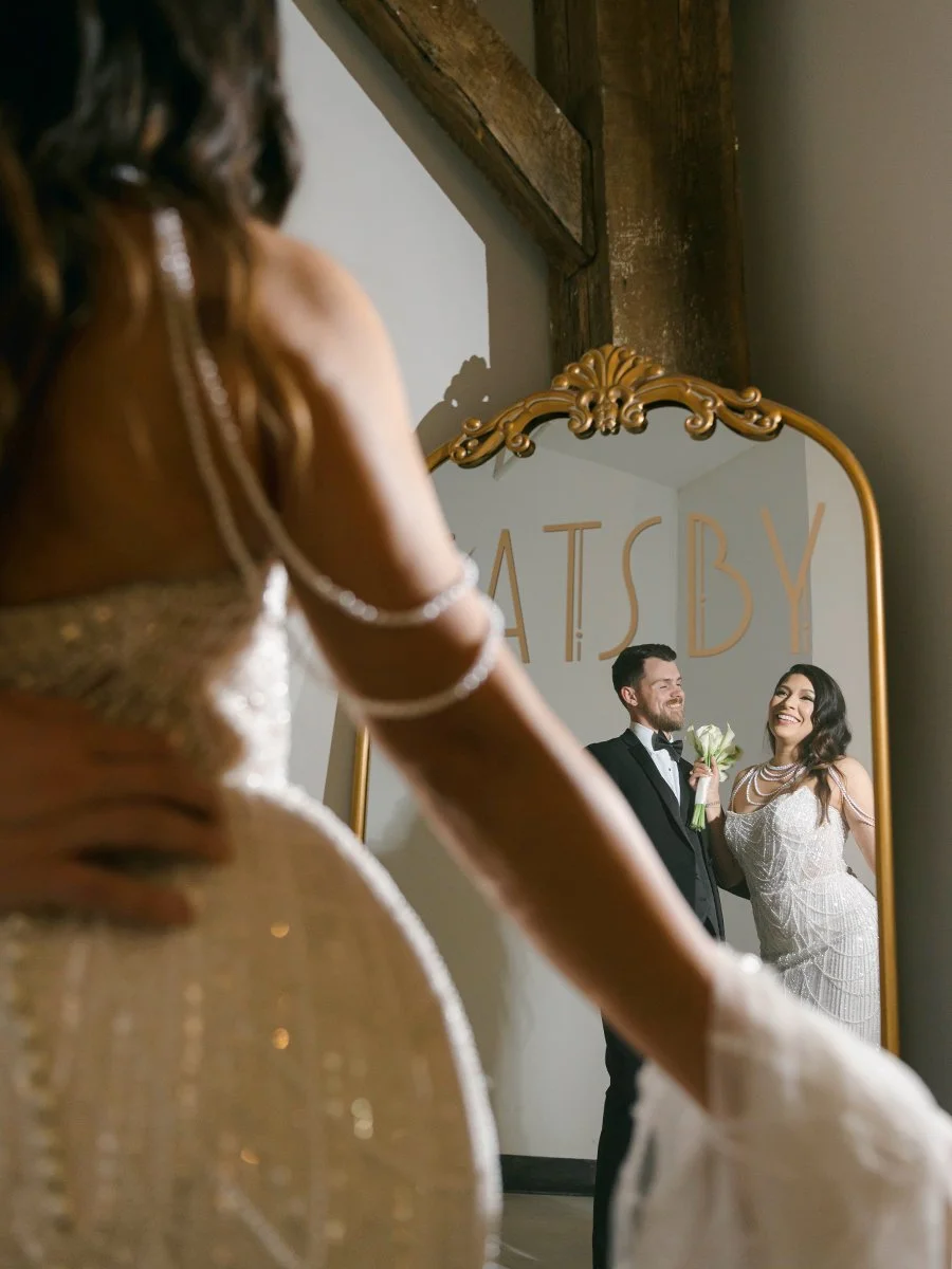 Bride and groom looking in a mirror at the Gatsby Event Venue in St. Louis.