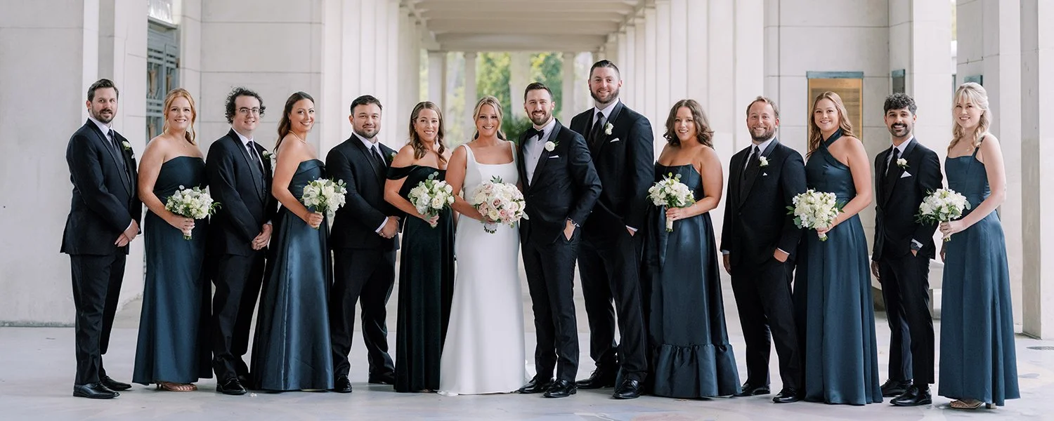 Wedding party holding blush and white rose bouquet inin St. Louis.