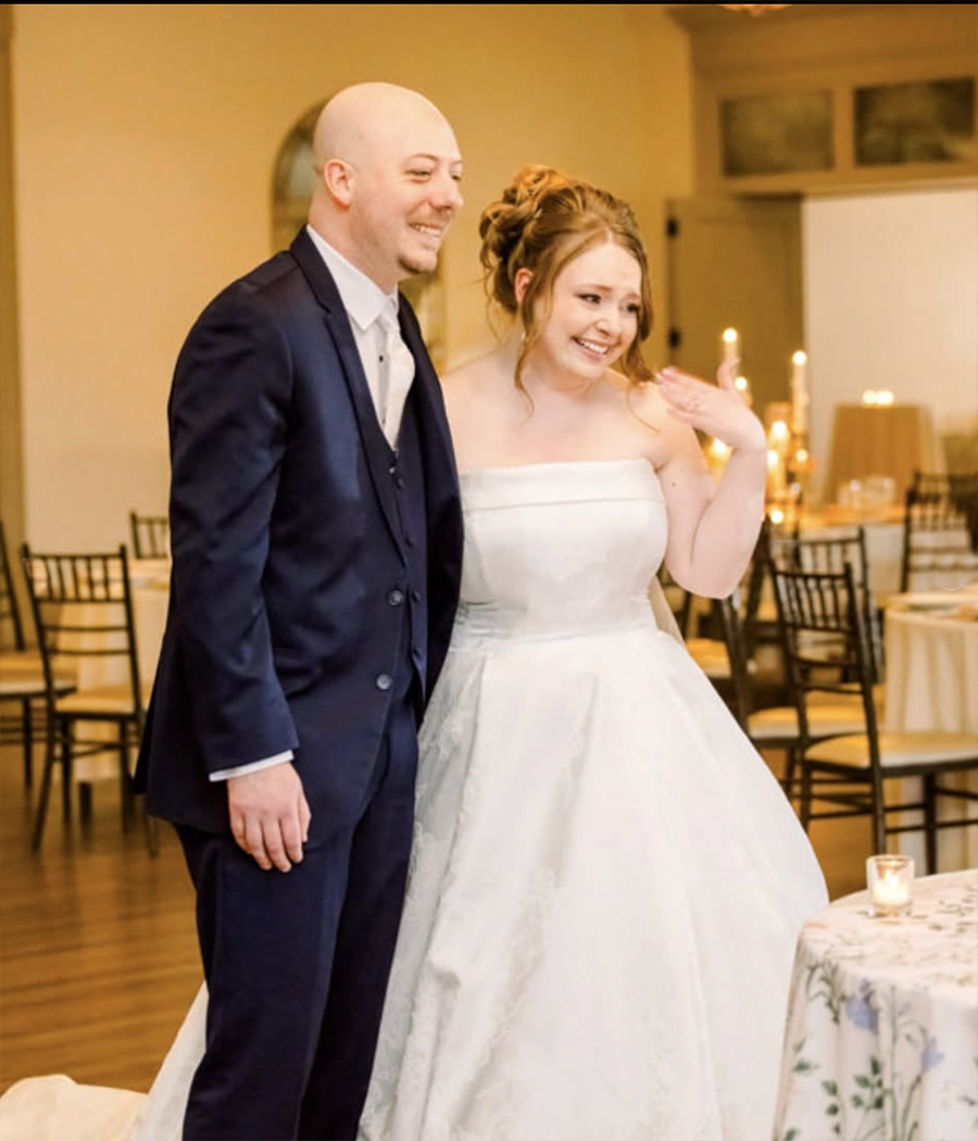 Bride and groom seeing their St. Louis wedding reception with flowers designed by Belli Fiori.