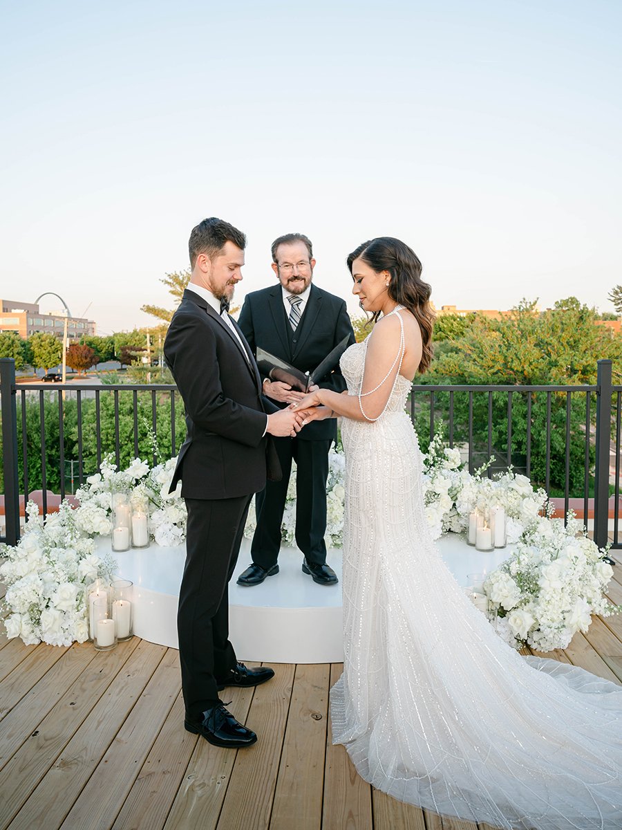 Bride and groom with white flower meadow for wedding ceremony at the Gatsby Events Venue in St. Louis.
