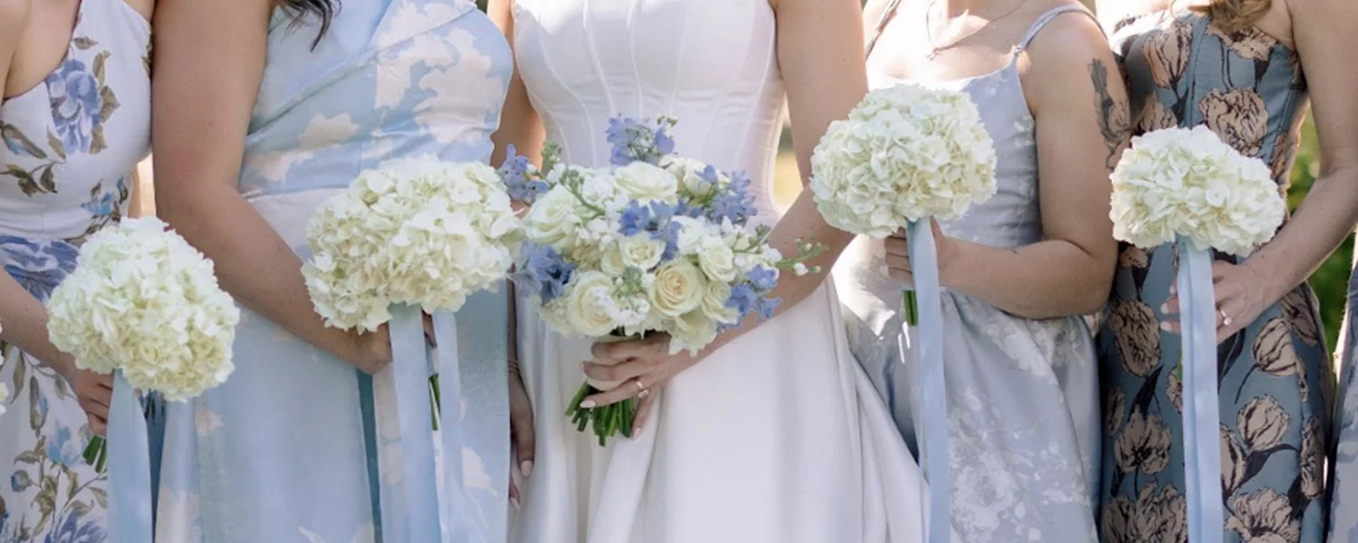 Blue and white colored bridal bouquet and bridesmaids bouquets designed by Belli Fiori in St. Louis.