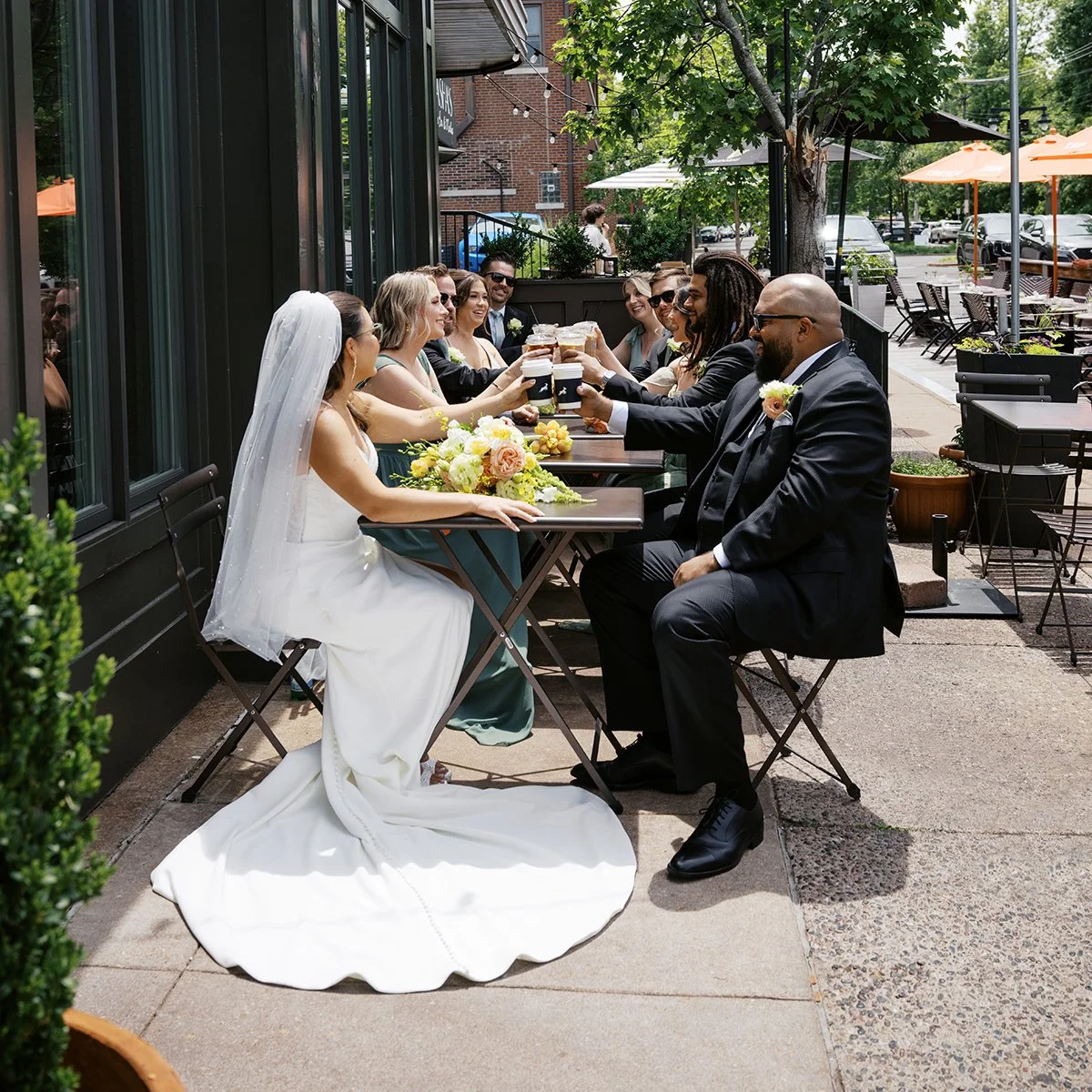 Bride and groom having coffee at their first date spot with flowers designed by Belli Fiori based in St. Louis.