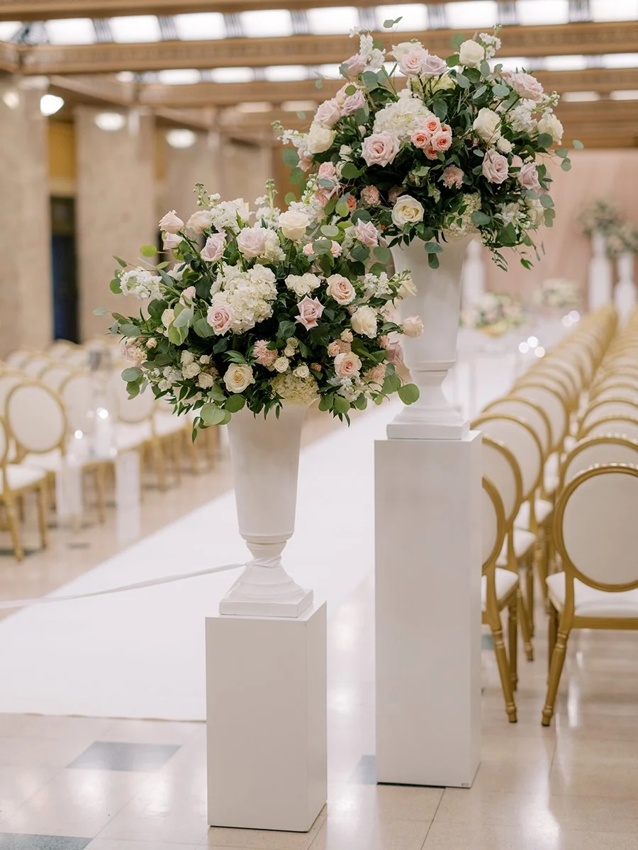 Wedding ceremony flowers with blush and white flowers for a wedding at the Stifel Theater in St. Louis.