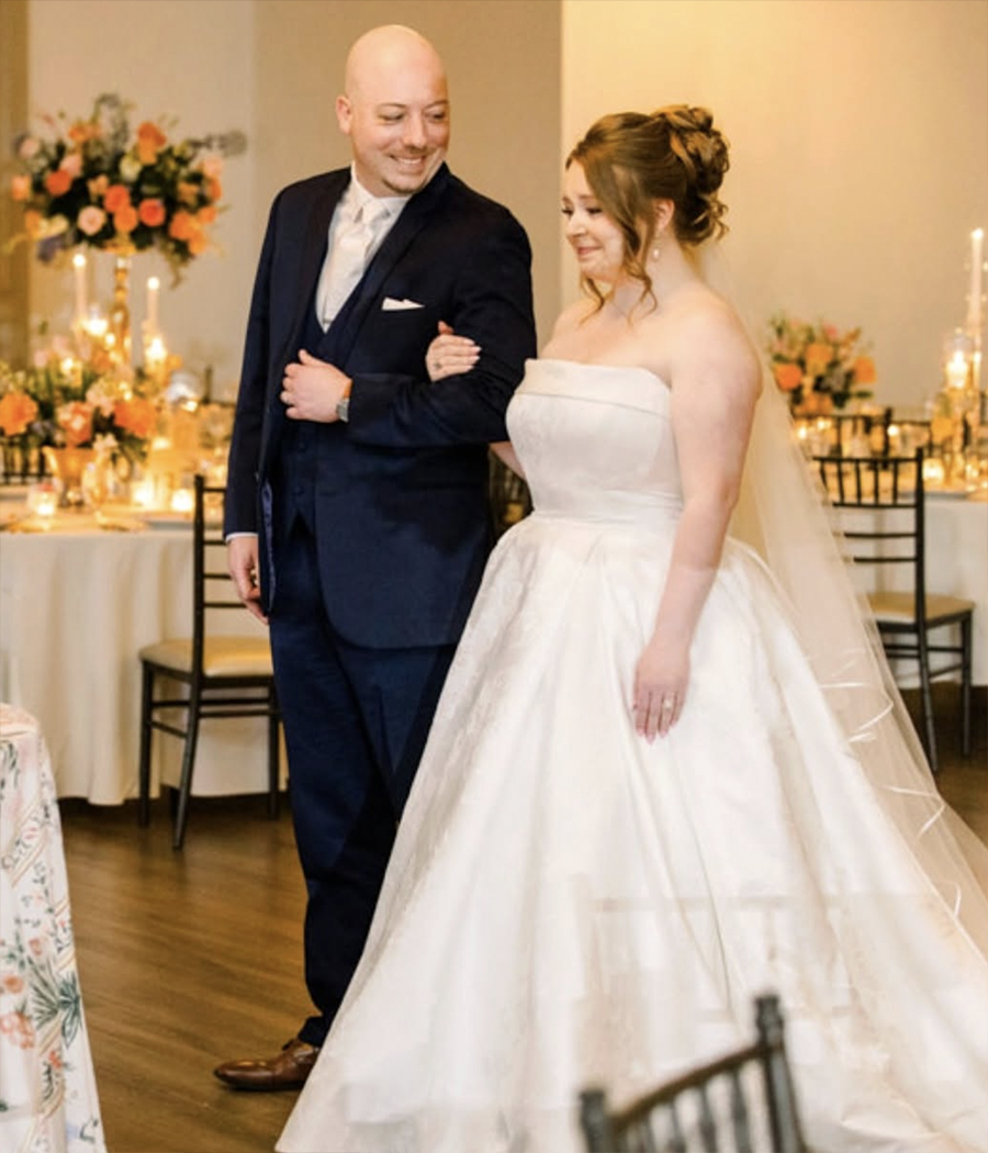 Bride and groom seeing their St. Louis wedding reception with flowers designed by Belli Fiori.