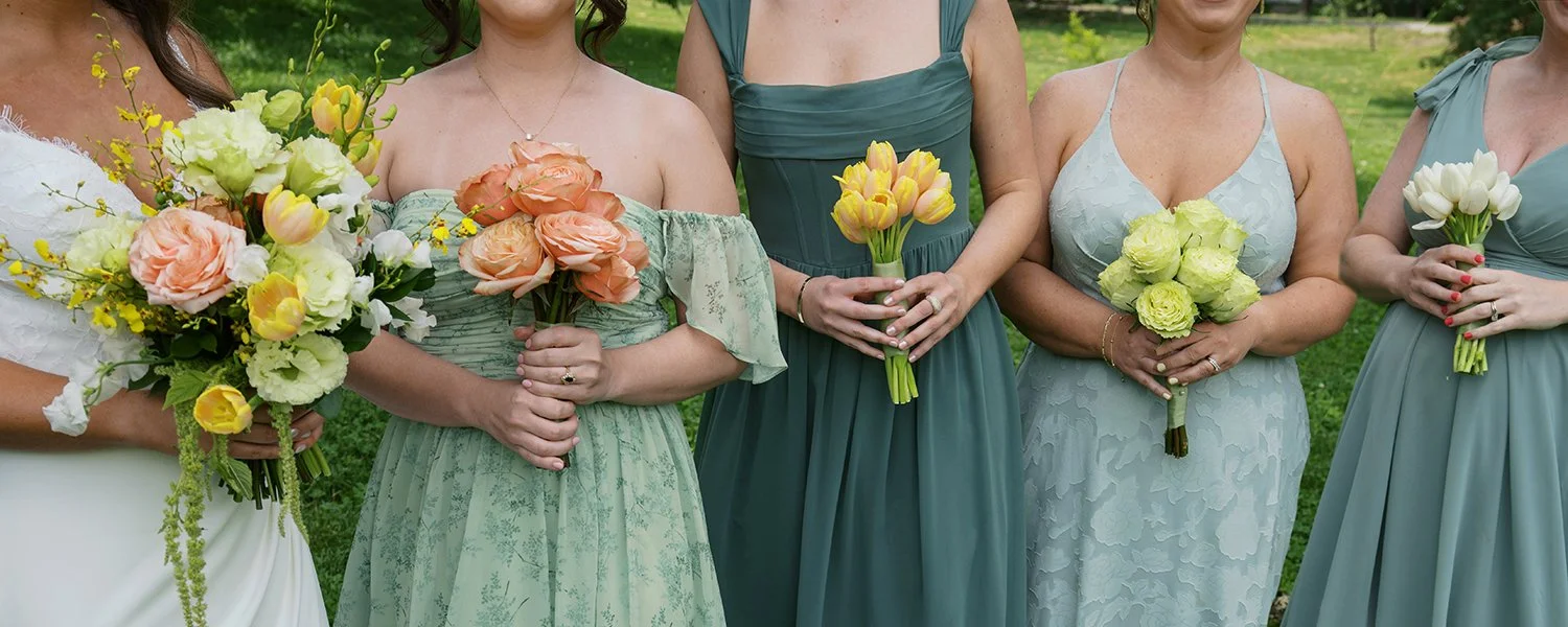 Bride and bridesmaids with wedding bouquets designed by Belli Fiori in St. Louis.