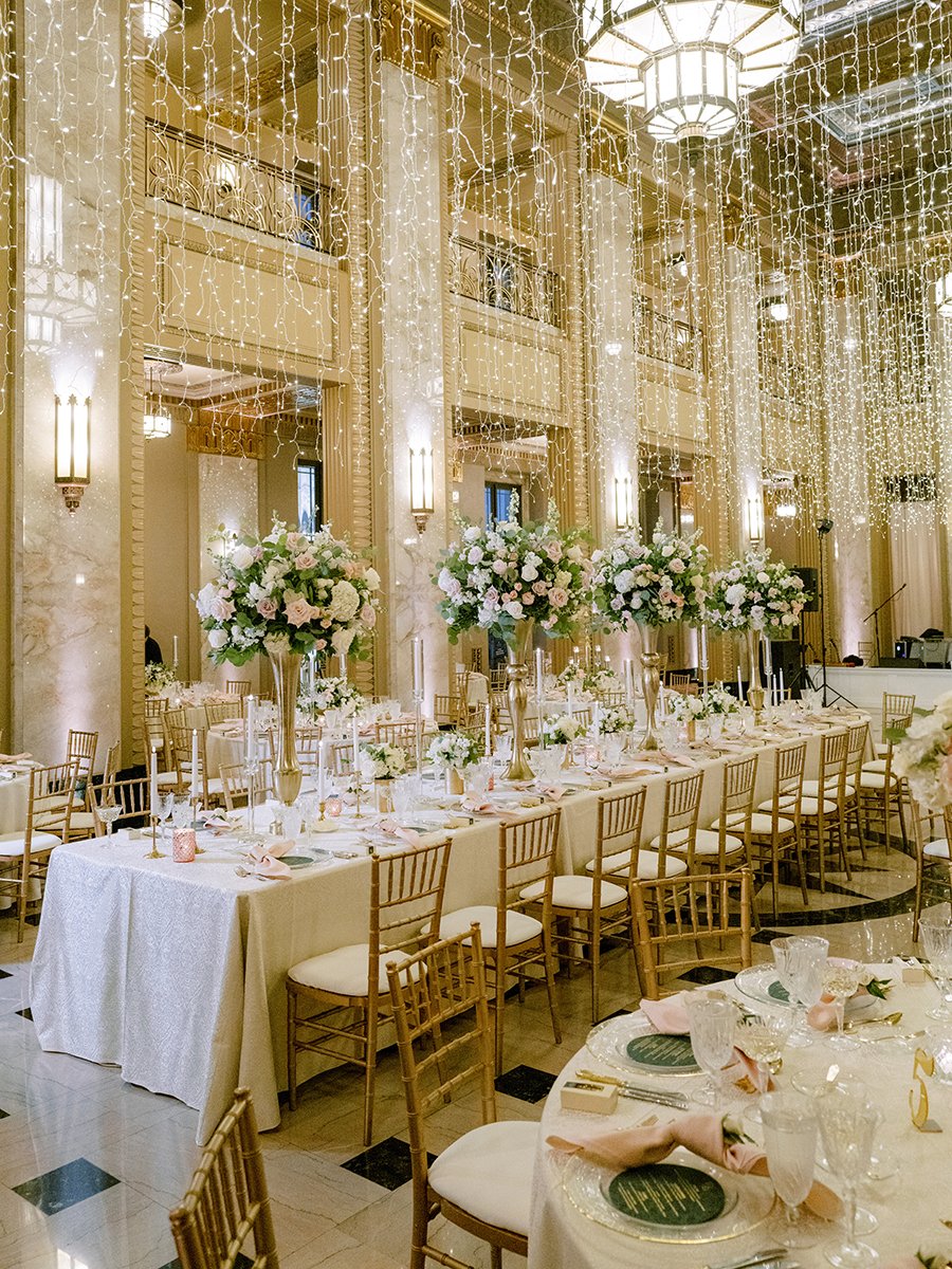 Wedding head table with blush and white rose centerpieces at the Stifel Theater in St. Louis.