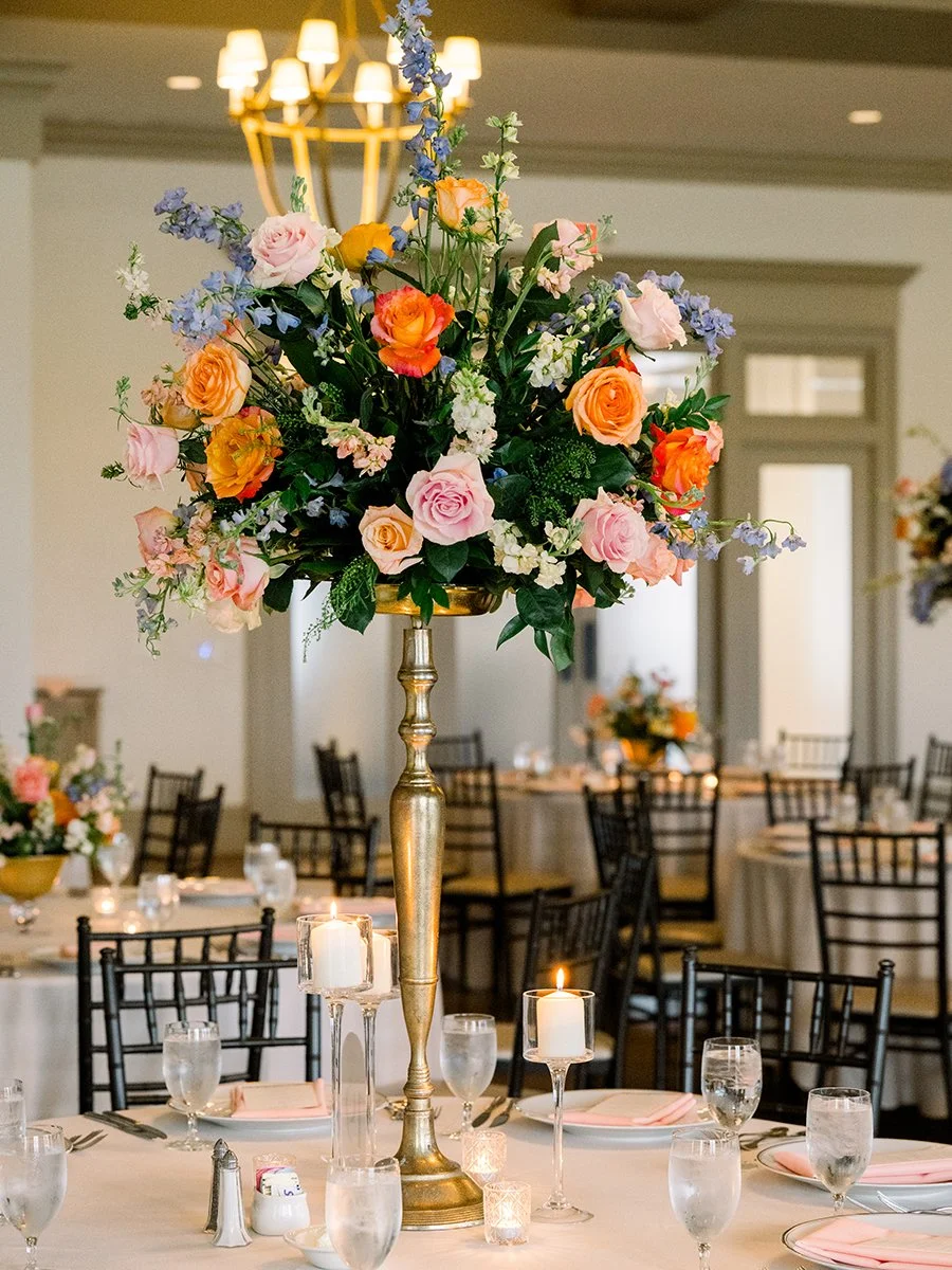 Colorful tall floral centerpiece designed by Belli Fiori for a wedding reception in St. Louis.