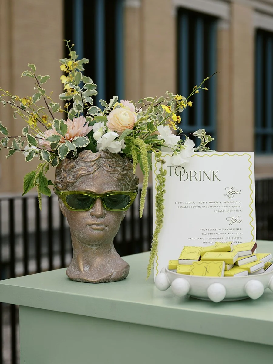 Wedding bar flower arrangement within a bust head at the St. Louis Art Museum with flowers deigned by Belli Fiori.