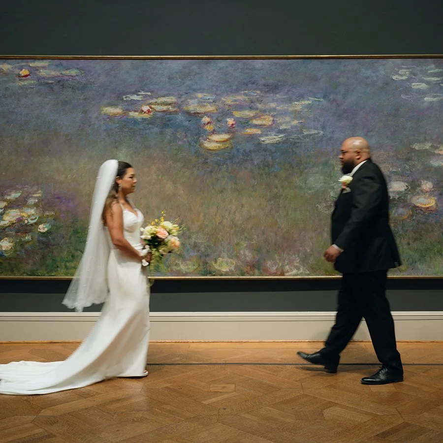 Bride and groom walking in the St. Louis Art Museum in front of the Monet painting with a bridal bouquet by Belli Fiori.