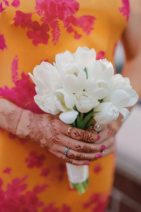 Brightly colored bridesmaid dress with a white tulip bouquet from Belli Fiori in St. Louis.